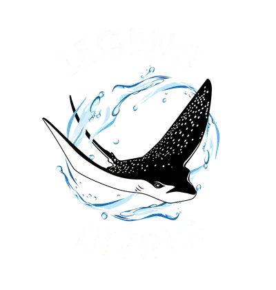 Spotted ray with white belly and speckled dark back swimming through blue water swirls, framed by bold white text LEGEND above and DIVING below.